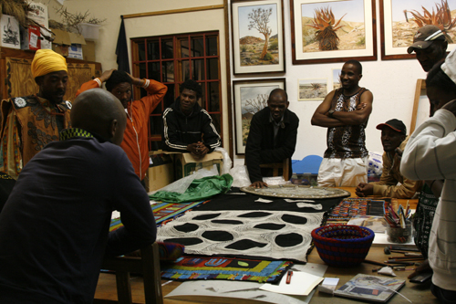The cast of Impethuku gather round my studio table to view my artwork